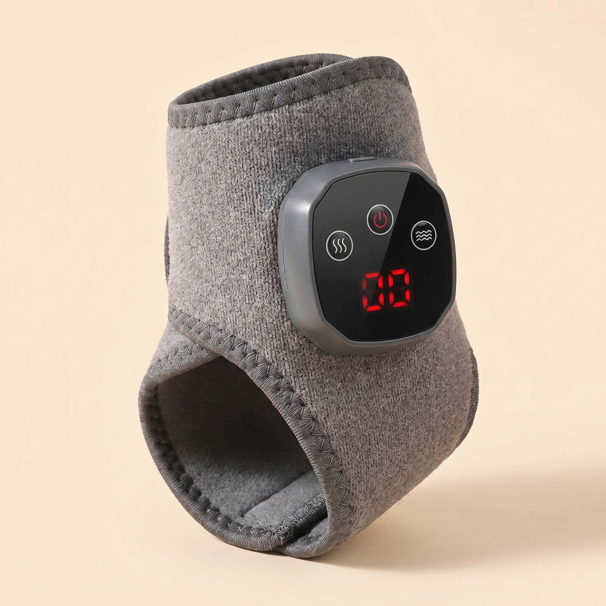 Tend heated ankle wrap studio product photo, three-quarter view showing the control display