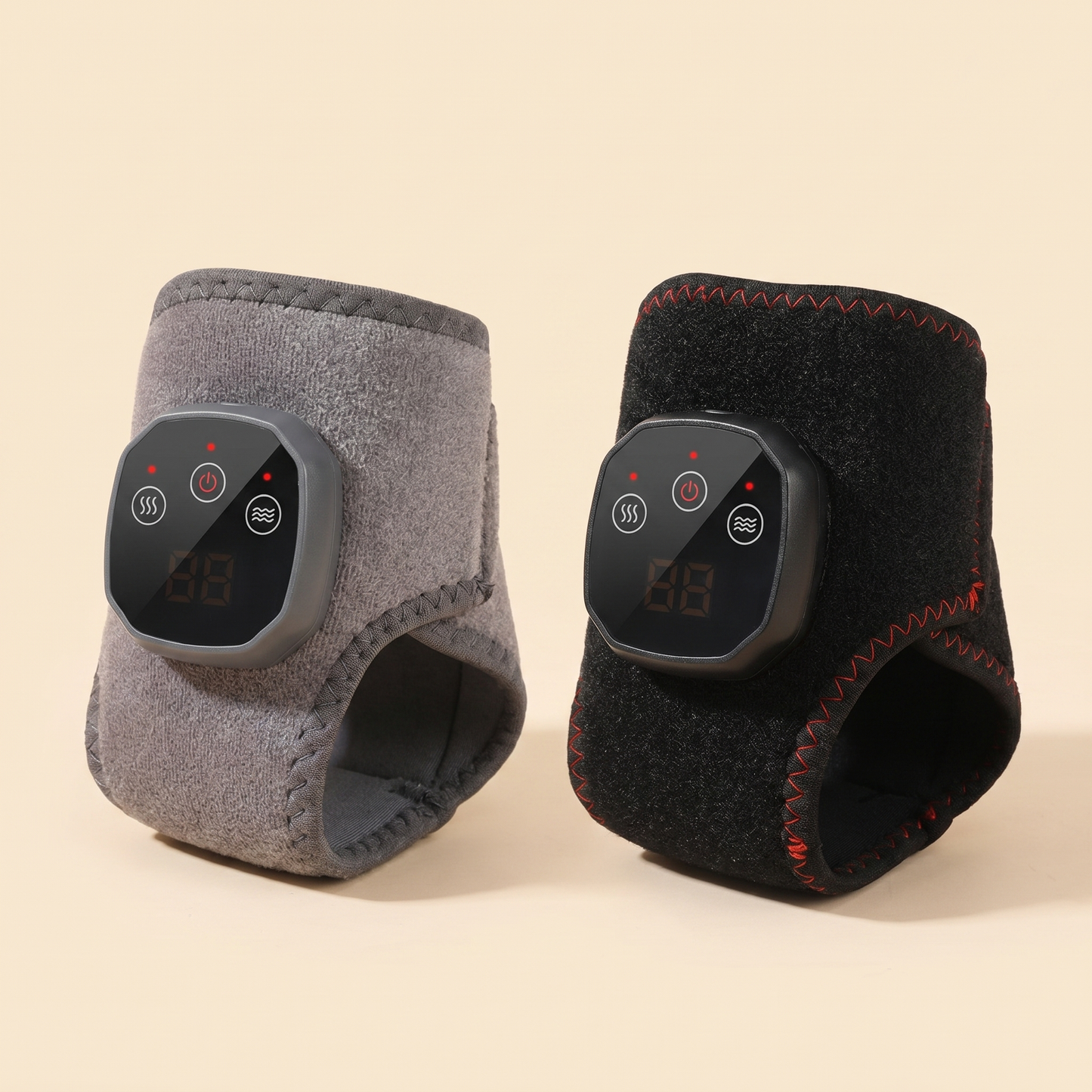 Two Tend heated ankle wraps in grey and black, studio product photo