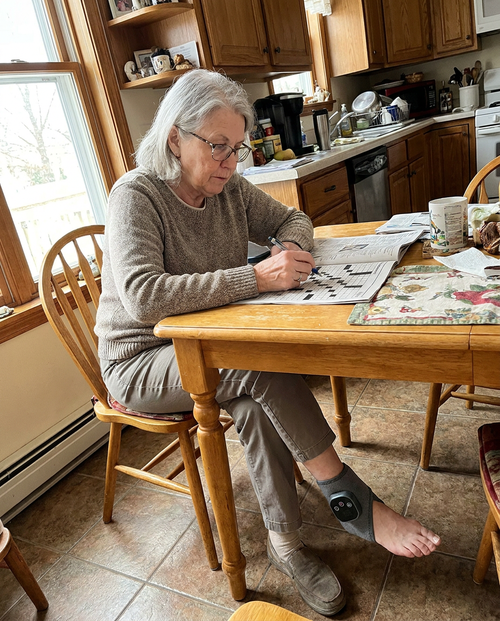 Customer photo, wearing Tend at the kitchen table